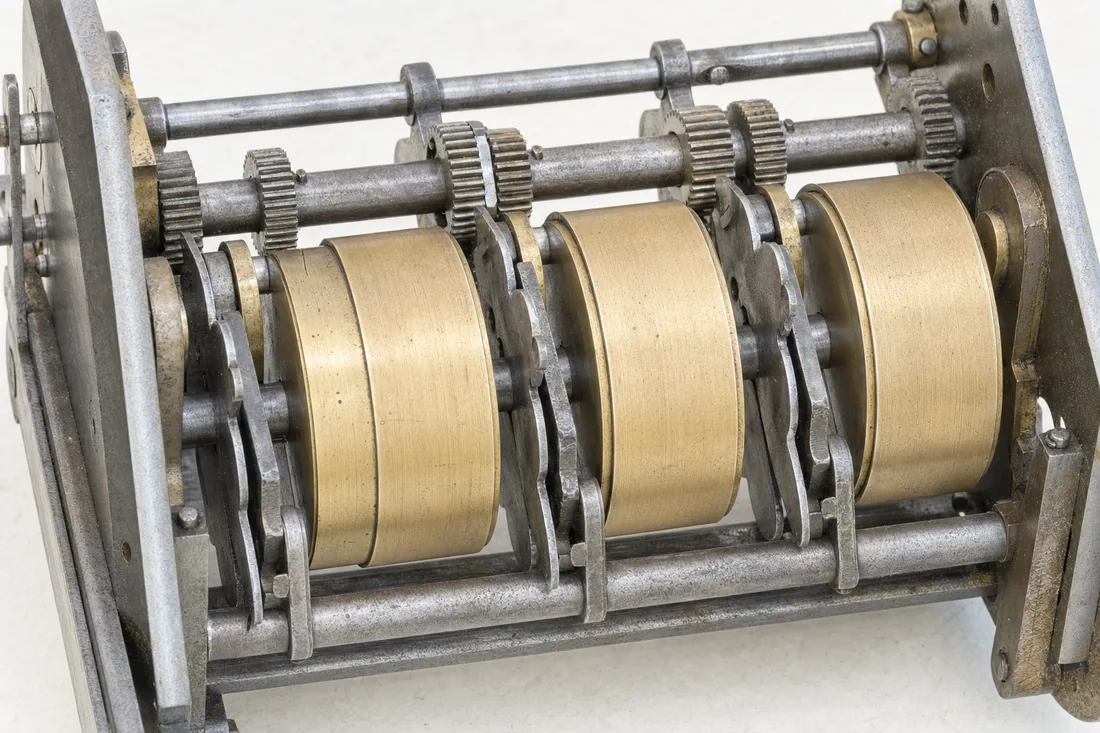 The brass drums and steel spindles of a mechanical counter mechanism